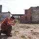 Dan Katz crouches in one of Detroit’s many vacant lots to study a bushel of ragweed.